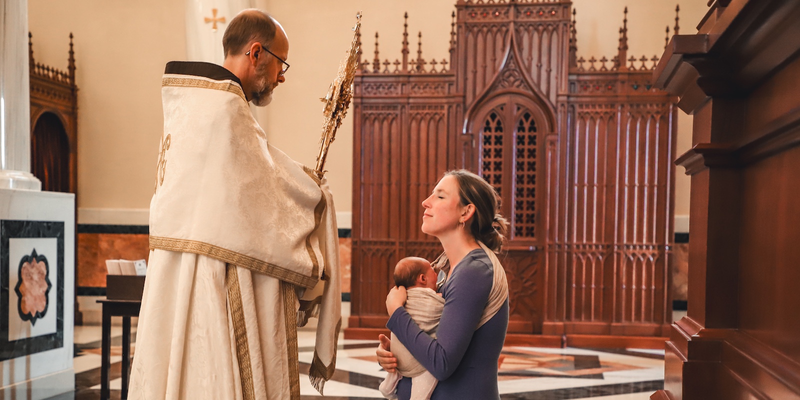 A woman kneeling for a benediction blessing